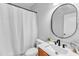 Cozy bathroom featuring a shower with tub, white toilet, modern sink and vanity, and round mirror at 2049 Rainy Lake St, Wake Forest, NC 27587