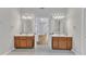Ensuite bathroom with double vanities, wood cabinets and bright lighting at 2049 Rainy Lake St, Wake Forest, NC 27587