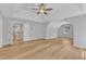 Spacious bedroom featuring a tray ceiling, ceiling fan, and wood-look floors at 2049 Rainy Lake St, Wake Forest, NC 27587