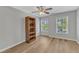 Bedroom with two bright windows, ceiling fan and natural wood-look floors at 2049 Rainy Lake St, Wake Forest, NC 27587