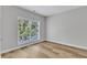 Bedroom with a large window offering abundant natural light and new hardwood flooring at 2049 Rainy Lake St, Wake Forest, NC 27587