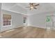 Bright bedroom with hardwood floors, many windows, and ensuite bathroom access at 2049 Rainy Lake St, Wake Forest, NC 27587