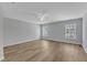 Large bedroom features two windows with natural lighting and wood-look floors at 2049 Rainy Lake St, Wake Forest, NC 27587