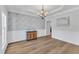 Formal dining room with hardwood floors, modern chandelier, and wainscoting at 2049 Rainy Lake St, Wake Forest, NC 27587