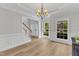 Dining room with hardwood floors, modern chandelier, and large windows at 2049 Rainy Lake St, Wake Forest, NC 27587