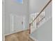 Bright foyer with hardwood floors, staircase, and a view into adjoining room at 2049 Rainy Lake St, Wake Forest, NC 27587