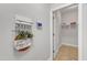 Hallway with decorative accents, leading to a laundry room and open floor plan at 2049 Rainy Lake St, Wake Forest, NC 27587
