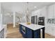 A modern kitchen featuring an island with a white countertop and stainless steel appliances at 2049 Rainy Lake St, Wake Forest, NC 27587