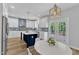 Bright kitchen with custom cabinets, a stylish blue backsplash, stainless appliances, and a center island at 2049 Rainy Lake St, Wake Forest, NC 27587