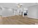 Spacious living room flows into an open floorplan with beautiful hardwood floors, ceiling fan, and bright lighting at 2049 Rainy Lake St, Wake Forest, NC 27587