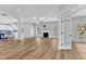 Open-concept living room with hardwood floors, fireplace, and access to kitchen at 2049 Rainy Lake St, Wake Forest, NC 27587