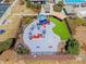 Aerial view of fenced playground featuring slides, climbing structures, and artificial turf at 2049 Rainy Lake St, Wake Forest, NC 27587