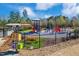 Fenced playground featuring slides, climbing structures, seating, and a library box at 2049 Rainy Lake St, Wake Forest, NC 27587