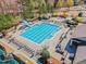 Aerial view of community pool with lounge chairs, outdoor kitchen, slide and tables at 2049 Rainy Lake St, Wake Forest, NC 27587