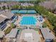 Aerial view of community pool, tennis courts, and outdoor sitting areas surrounded by trees at 2049 Rainy Lake St, Wake Forest, NC 27587