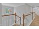 Upstairs landing featuring wooden banisters, hardwood floors, and a view of the foyer at 2049 Rainy Lake St, Wake Forest, NC 27587