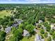 Aerial view of neighborhood with mature trees, grassy lawns, and winding roads at 210 Mediate Dr, Raleigh, NC 27603
