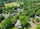 Neighborhood aerial view with mature trees, grassy lawns, and winding roads at 210 Mediate Dr, Raleigh, NC 27603