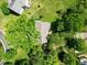 Aerial view of a single story home surrounded by mature trees and green lawn at 210 Mediate Dr, Raleigh, NC 27603