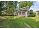 Large landscaped backyard with siding, patio, and large windows at 210 Mediate Dr, Raleigh, NC 27603