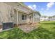 Backyard features a small brick patio and green lawn at 210 Mediate Dr, Raleigh, NC 27603