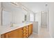 Bathroom with double sinks, wood vanity, and neutral tones at 210 Mediate Dr, Raleigh, NC 27603