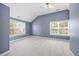 Vaulted ceiling primary bedroom with two large windows and neutral carpet at 210 Mediate Dr, Raleigh, NC 27603