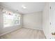 Bright bedroom featuring carpeted floors and a large window at 210 Mediate Dr, Raleigh, NC 27603
