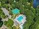 Aerial view of a community pool with seating, tennis courts, parking, and landscaping at 210 Mediate Dr, Raleigh, NC 27603