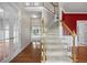 Inviting foyer with hardwood floors, staircase, and white trim at 210 Mediate Dr, Raleigh, NC 27603