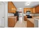 Traditional kitchen featuring wood cabinets, tiled floors, and a black refrigerator at 210 Mediate Dr, Raleigh, NC 27603