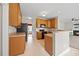 Traditional kitchen featuring wood cabinets, tiled floors, and a black oven at 210 Mediate Dr, Raleigh, NC 27603