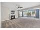 Spacious living room with fireplace, ceiling fan, and lots of natural light at 210 Mediate Dr, Raleigh, NC 27603
