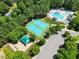 Aerial view of community tennis courts, playground, pool, parking, and landscaping at 210 Mediate Dr, Raleigh, NC 27603