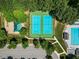 Aerial view of community tennis courts and playground with parking and landscaping at 210 Mediate Dr, Raleigh, NC 27603