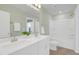 Bright bathroom with double vanity, white cabinets, large mirror, and a separate toilet and shower area at 212 Brook Farm Ln, Fuquay Varina, NC 27526