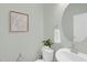 Charming half bathroom features a round mirror, modern fixtures, and a unique map artwork at 212 Brook Farm Ln, Fuquay Varina, NC 27526