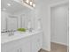 Well-lit bathroom featuring a double vanity with modern faucets, a large mirror, and neutral decor at 212 Brook Farm Ln, Fuquay Varina, NC 27526