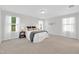 Spacious bedroom with plush carpet, three windows with sheer curtains and two side tables with lamps at 212 Brook Farm Ln, Fuquay Varina, NC 27526