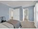 Inviting bedroom with a bathroom and walk-in closet with blue walls, carpet flooring, and natural light at 212 Brook Farm Ln, Fuquay Varina, NC 27526