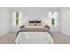 Well-lit bedroom with plush carpet, two windows with sheer curtains and two side tables with lamps at 212 Brook Farm Ln, Fuquay Varina, NC 27526