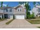 Charming two-story townhome featuring a one car garage and craftsman style architecture at 212 Brook Farm Ln, Fuquay Varina, NC 27526