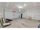 Spacious unfinished two-car garage with a neutral interior, and overhead door at 212 Brook Farm Ln, Fuquay Varina, NC 27526