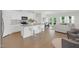 Open-concept kitchen with an island, stainless steel appliances, and hardwood floors at 212 Brook Farm Ln, Fuquay Varina, NC 27526