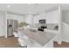 Bright kitchen featuring an island with granite countertops, stainless steel appliances and white cabinetry at 212 Brook Farm Ln, Fuquay Varina, NC 27526