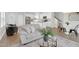 Open-concept living room flows into kitchen with stainless steel appliances, and features stylish decor and modern finishes at 212 Brook Farm Ln, Fuquay Varina, NC 27526