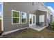 Outdoor patio with a table and chairs surrounded by a well-maintained backyard at 212 Brook Farm Ln, Fuquay Varina, NC 27526