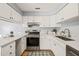 Bright kitchen features white cabinets, stainless steel appliances, and durable solid surface countertops at 213 Summerwalk Cir, Chapel Hill, NC 27517