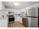 Modern kitchen featuring stainless steel appliances, granite countertops, and white cabinetry at 213 Summerwalk Cir, Chapel Hill, NC 27517