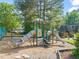 Community playground with slides and play structures, surrounded by trees and mulch at 213 Summerwalk Cir, Chapel Hill, NC 27517